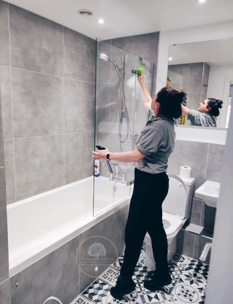 Country Cleaners staff cleaning a shower cubicle in Cullompton