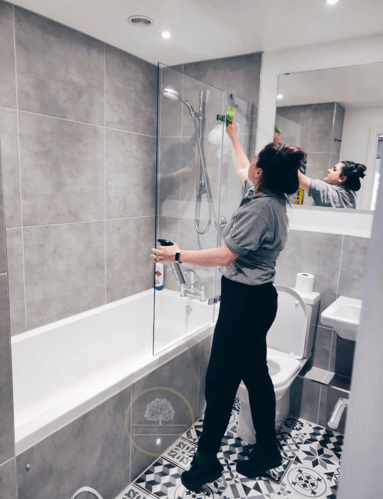 Country Cleaners staff cleaning a shower cubicle in Cullompton